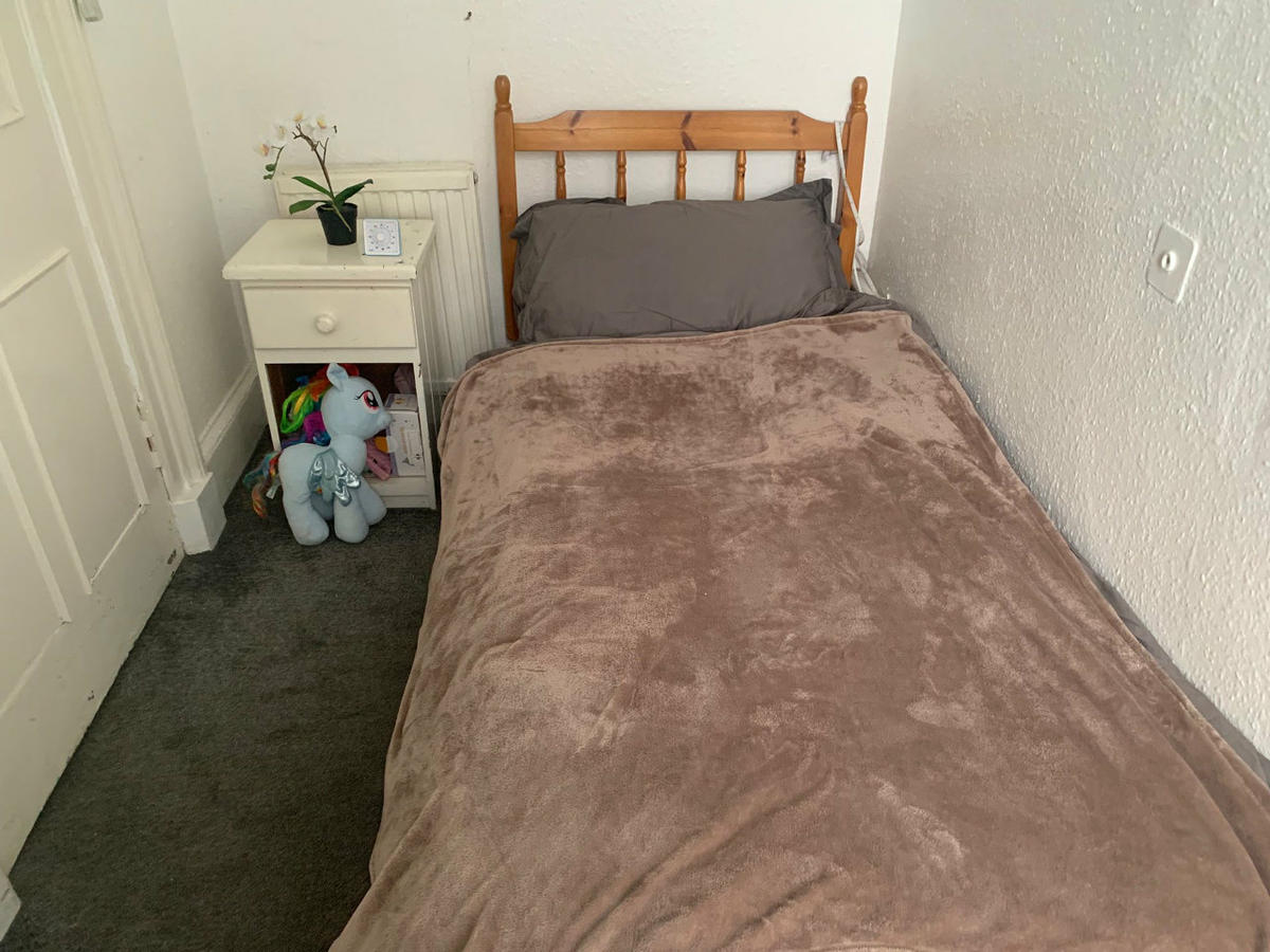 Small room with a single bed has a nice view of the garden and the sea