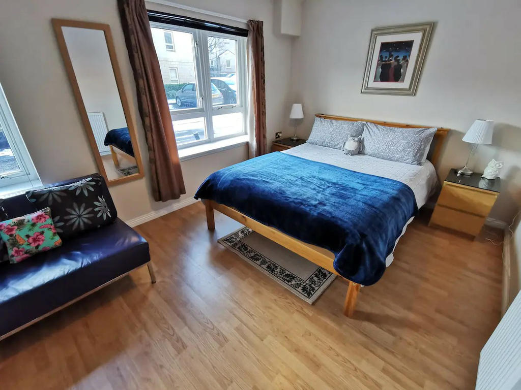 Double bedroom 2 with double bed, bedside cabinets, sofa and wardrobes