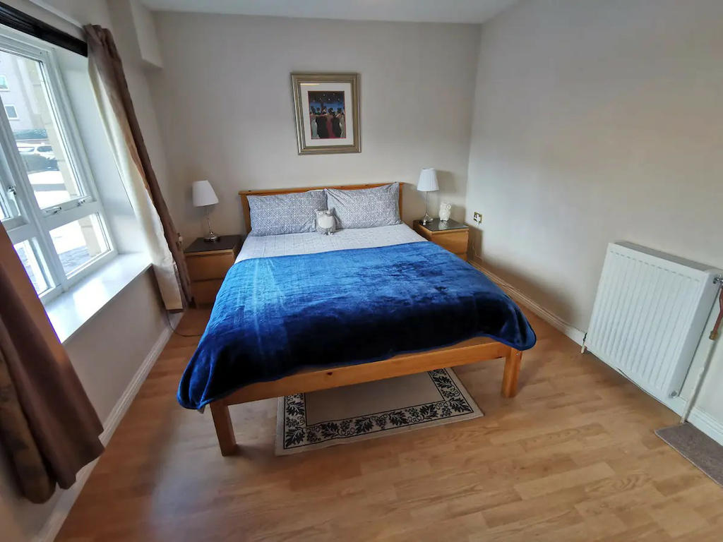 Double bedroom 2 with double bed, bedside cabinets, sofa and wardrobes