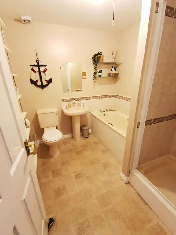 Spacious bathroom with fitted walk in shower and bath