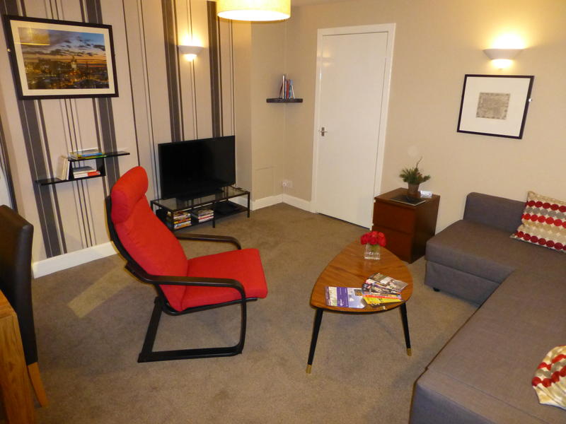 The living room with TV, DVD player and double sofabed