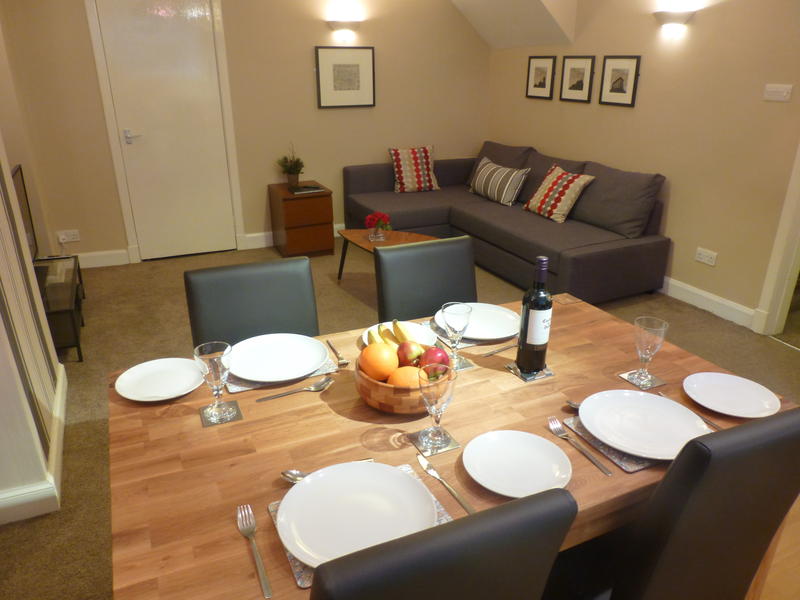 Living room with dining area and kitchen behind