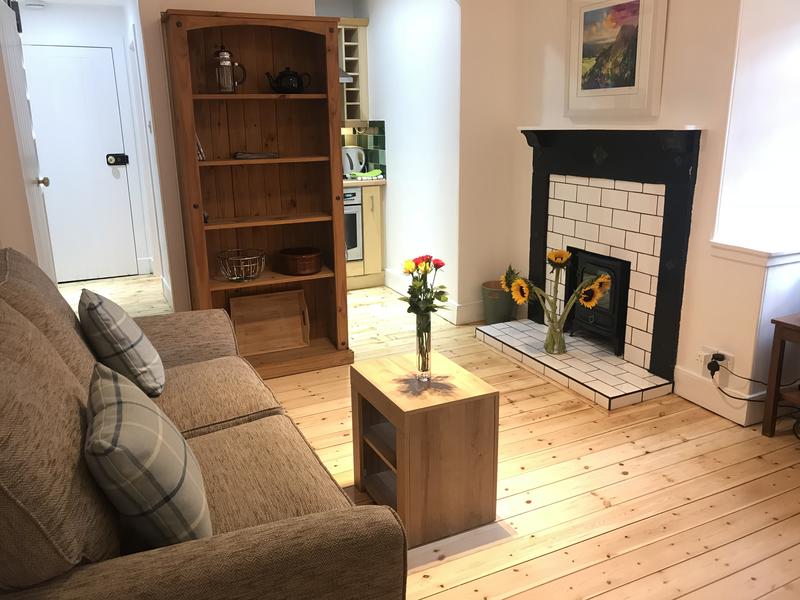 Living-room (with double sofabed) with dining area and kitchen area