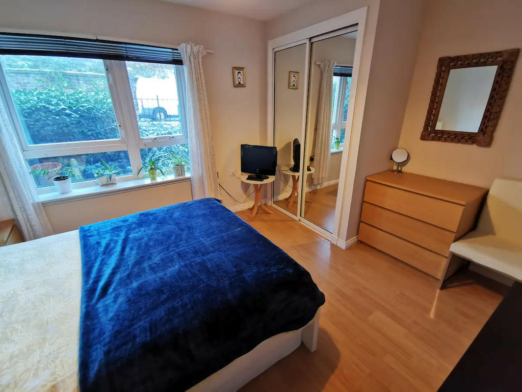 Double bedroom 1 with mirrored wardrobe, bedside cabinet, chest of drawers, TV and a small sofa