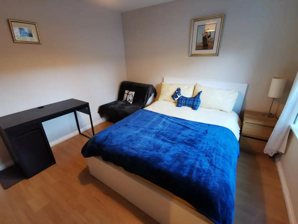 Double bedroom 1 with mirrored wardrobe, bedside cabinet, chest of drawers, TV and a small sofa