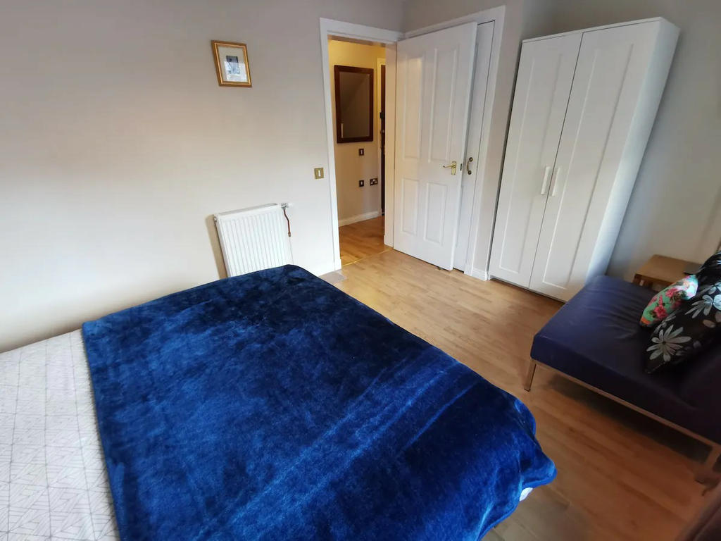 Double bedroom 2 with double bed, bedside cabinets, sofa and wardrobes