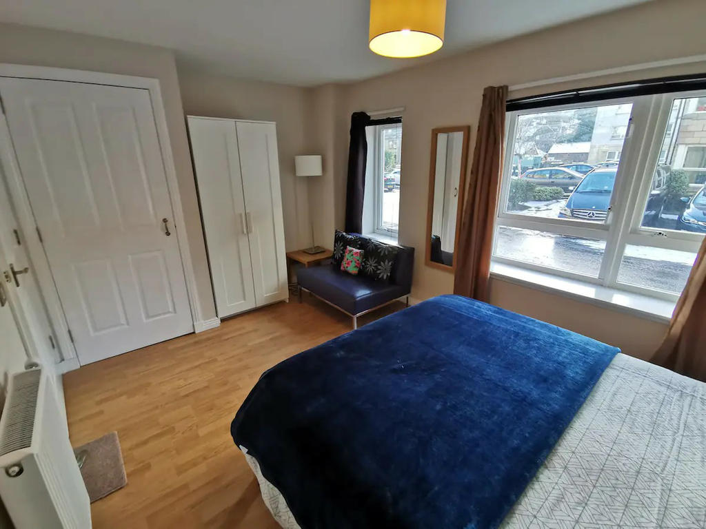 Double bedroom 2 with double bed, bedside cabinets, sofa and wardrobes