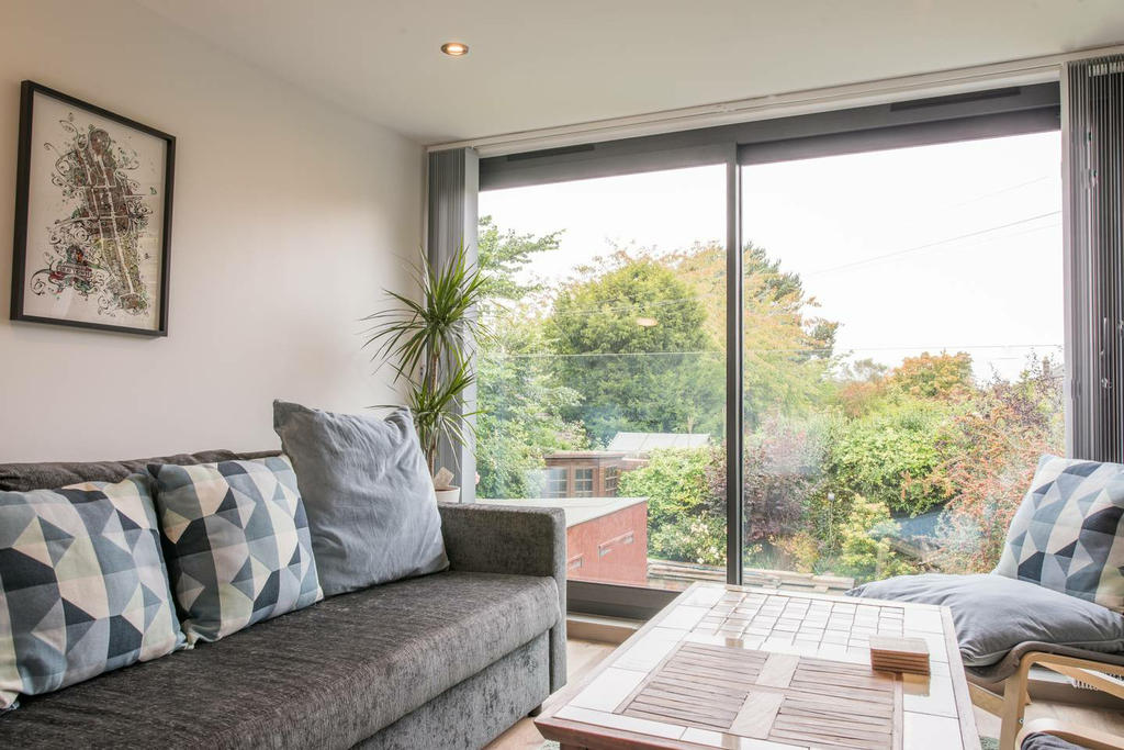 Sun Room with Smart TV on first floor doubles as bedroom with sofa bed