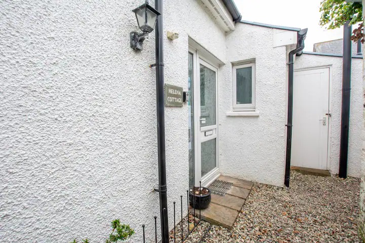 Front door and outhouse containing (washer/dryer)