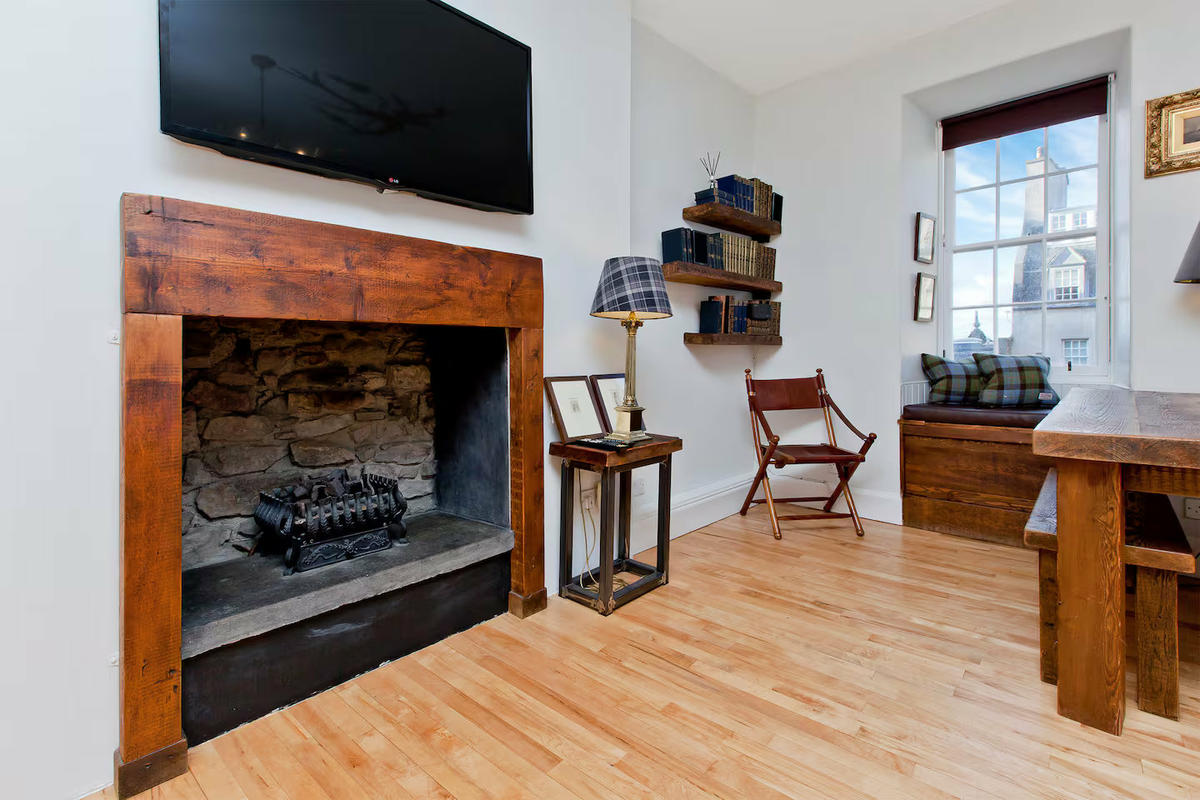 Living/dining area with rustic stone fire placeLiving/dining area with rustic stone fire place
