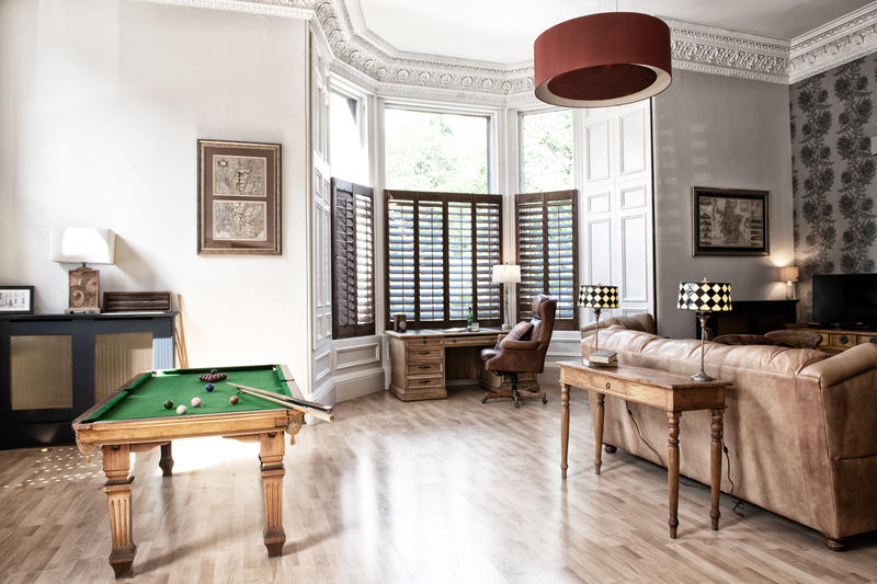 There's a dining table in the living room which converts into a pool table